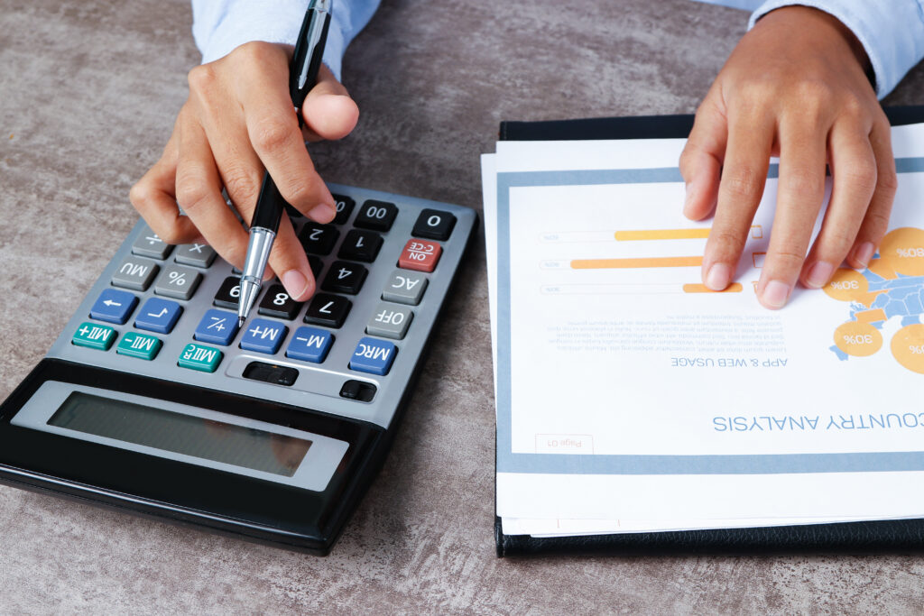 Closeup of an analyst using a calculator