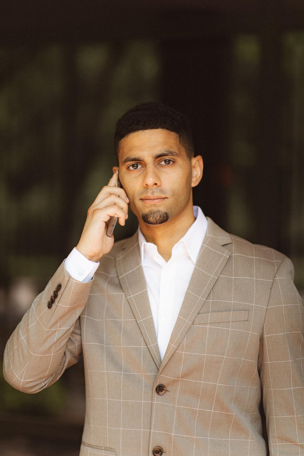 Amir Soliman, founder of Elite Finance Team, holding a phone - SBA loans New Jersey
